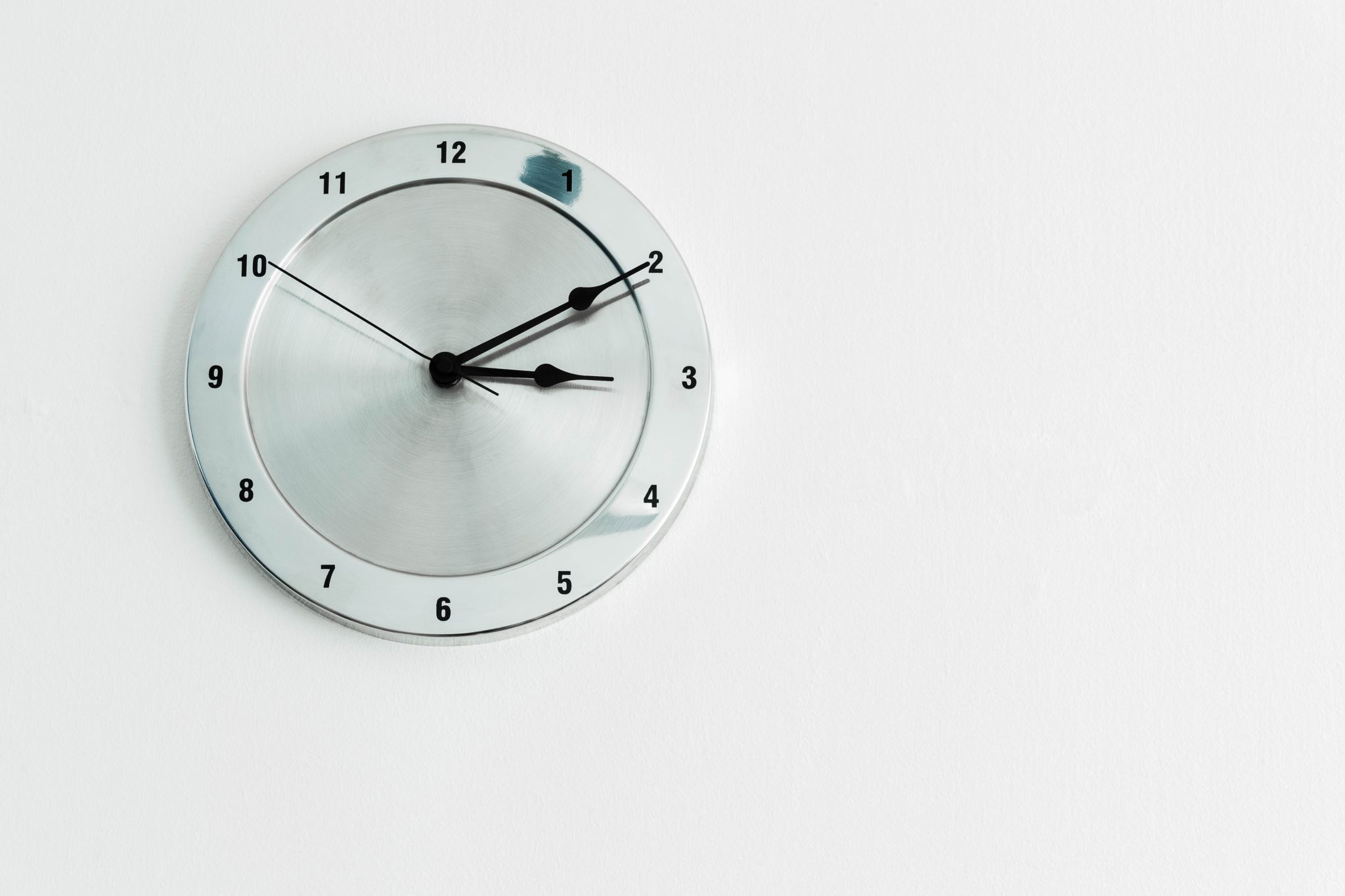 real-time analytics chrome clock hanging on white wall